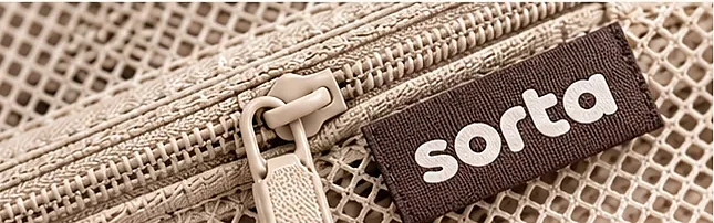 Close-up of a zip pull and the woven Sorta label on the mesh.